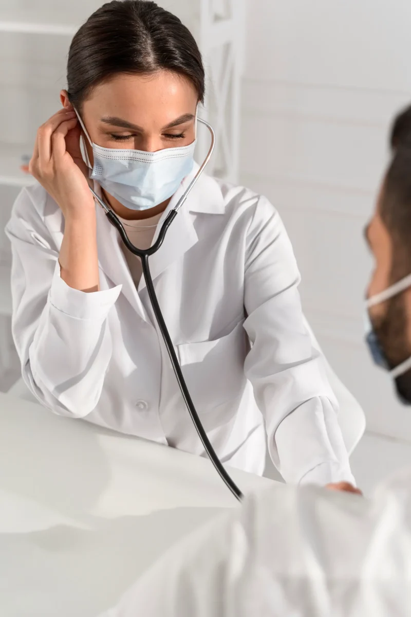 nurse-using-stethoscope-young-man